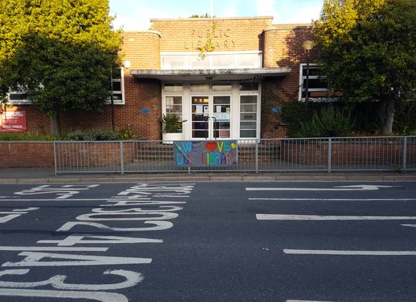 Cobbett Road Library from across road with banner summer 22 600px