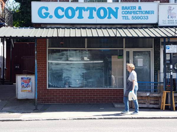 cottons bakery soon to be plested woman walking past 600px 3 5 23